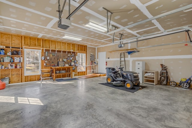 garage with a garage door opener and a workshop area