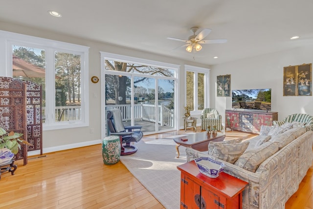 living room featuring baseboards, ceiling fan, recessed lighting, and wood-type flooring