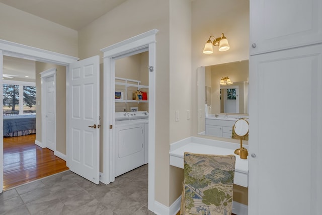 bathroom with washer and clothes dryer, tile patterned flooring, and vanity