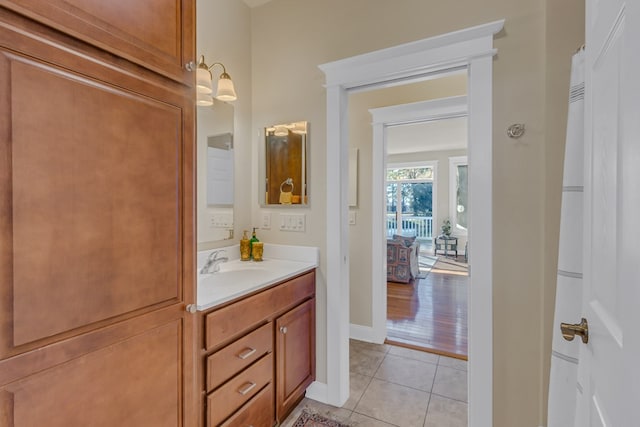 bathroom with tile patterned floors, vanity, and baseboards