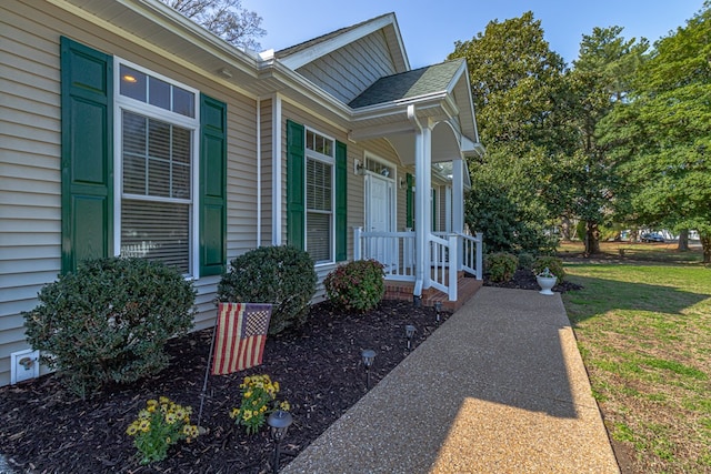 view of property exterior featuring a lawn and a shingled roof