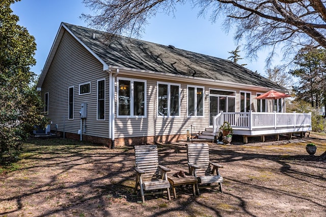 back of property with a wooden deck