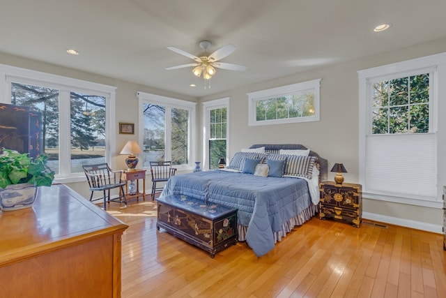 bedroom featuring multiple windows, light wood finished floors, and recessed lighting