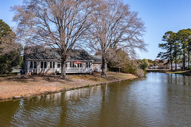 exterior space with a deck with water view