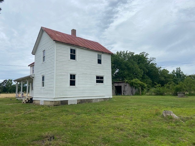2831 Oakland Rd, Farnham, VA 22460 - view of property exterior with a chimney, a lawn, and metal roof