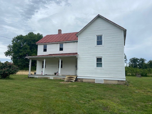 2831 Oakland Rd, Farnham, VA 22460 - rear view of house featuring covered porch, a lawn, a chimney, and metal roof