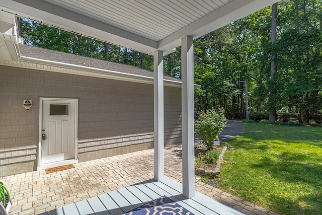604 High Point Trl, Heathsville, VA 22473 - property entrance with a yard, roof with shingles, and a patio area