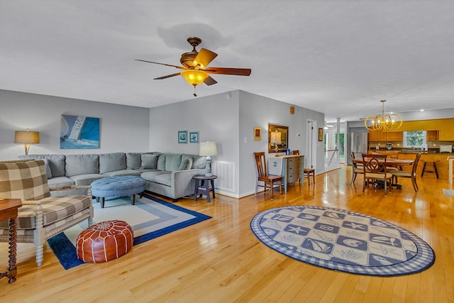 604 High Point Trl, Heathsville, VA 22473 - living room featuring light wood finished floors, a chandelier, and a ceiling fan