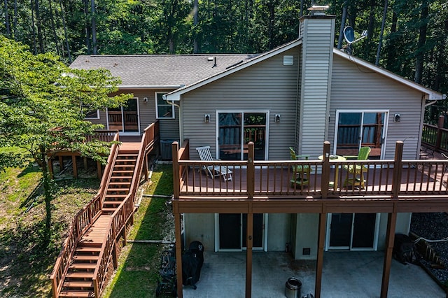 604 High Point Trl, Heathsville, VA 22473 - back of house featuring stairs, a patio area, a deck, a chimney, and roof with shingles