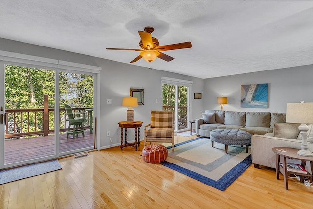 604 High Point Trl, Heathsville, VA 22473 - living room with light wood-style floors, ceiling fan, and a textured ceiling