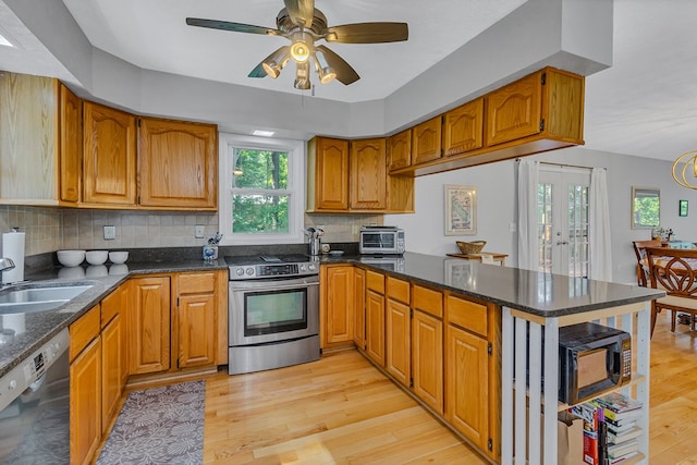 604 High Point Trl, Heathsville, VA 22473 - kitchen featuring electric range, dishwasher, a peninsula, brown cabinetry, and light wood finished floors