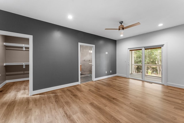 unfurnished bedroom featuring light wood-type flooring, access to outside, ceiling fan, connected bathroom, and a closet