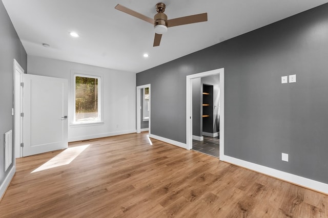 spare room featuring ceiling fan and light wood-type flooring