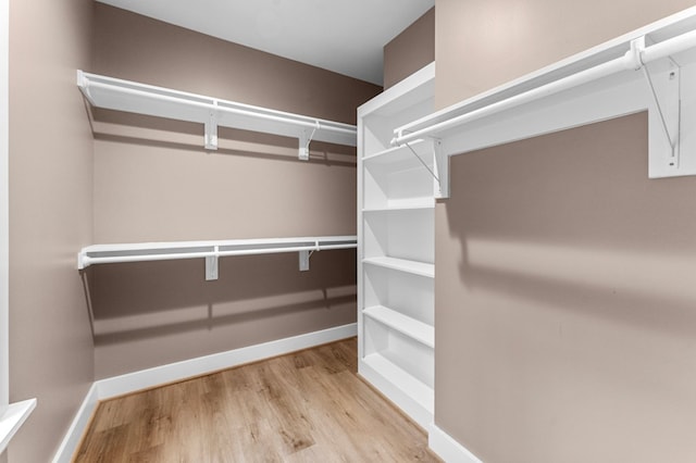 spacious closet featuring light hardwood / wood-style floors