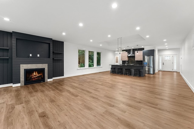 living room featuring a fireplace and light hardwood / wood-style flooring