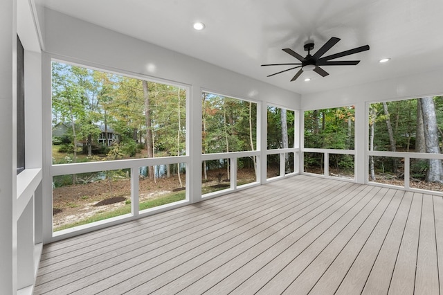 unfurnished sunroom with ceiling fan