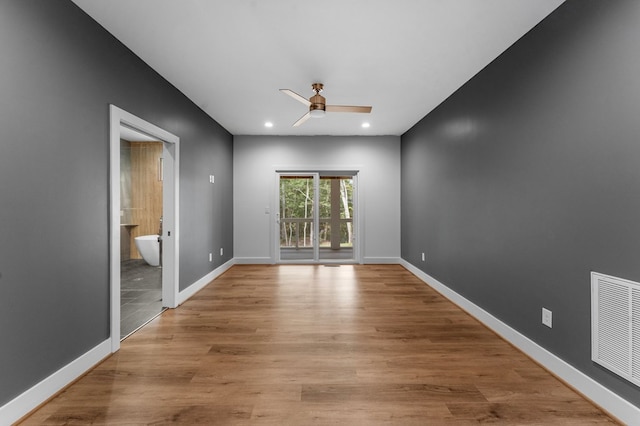 unfurnished room with ceiling fan and light wood-type flooring