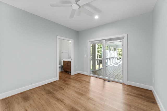 empty room with ceiling fan and light hardwood / wood-style flooring