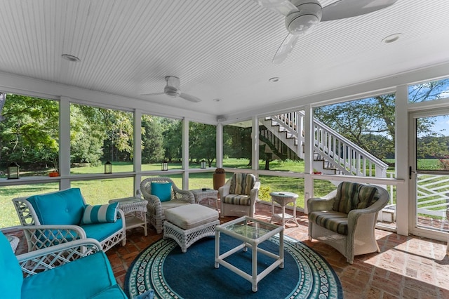 sunroom / solarium featuring ceiling fan