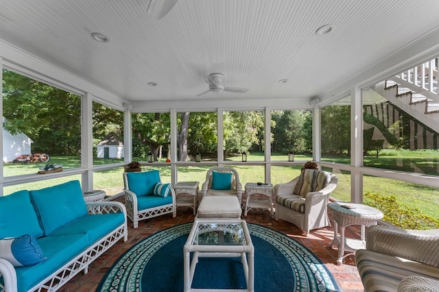 sunroom with a wealth of natural light and ceiling fan