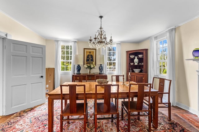 dining space with a chandelier and crown molding