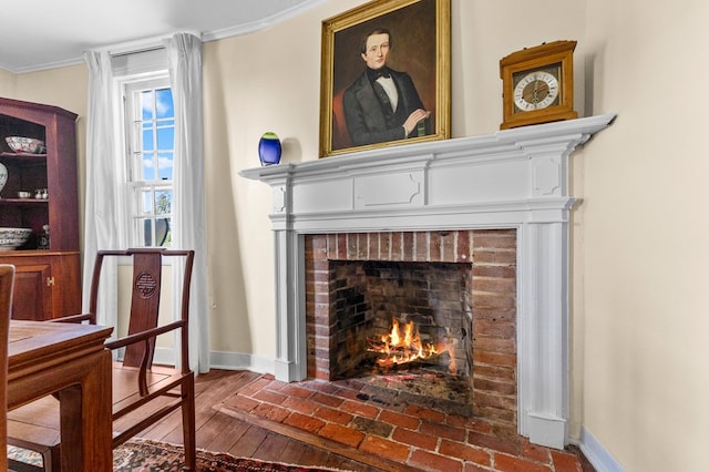 sitting room with a fireplace, crown molding, and hardwood / wood-style floors