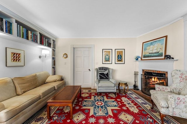 living room with ornamental molding and a fireplace