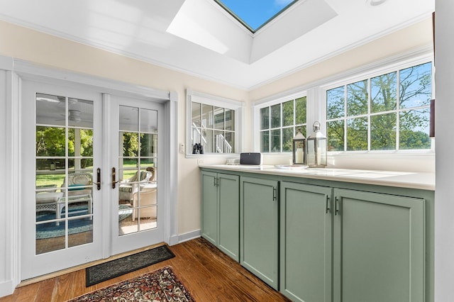 sunroom / solarium featuring french doors, a skylight, and a wealth of natural light