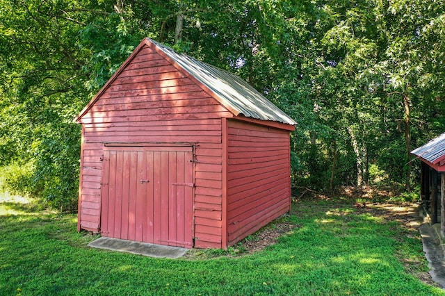 view of outbuilding with a yard