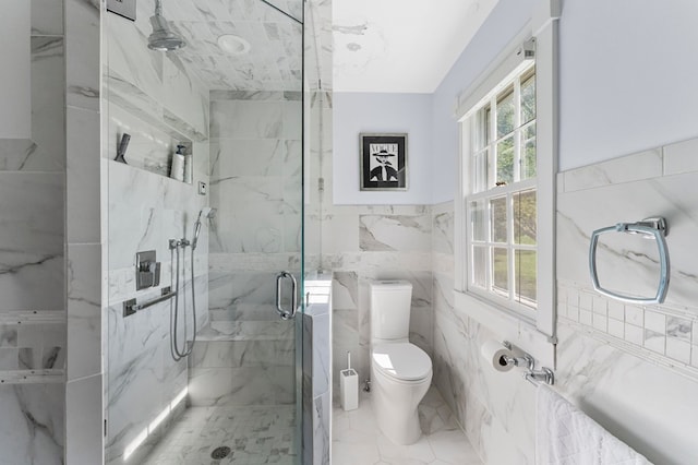 bathroom with an enclosed shower, toilet, and tile walls