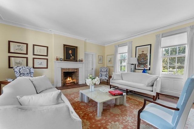 living room featuring crown molding and a brick fireplace