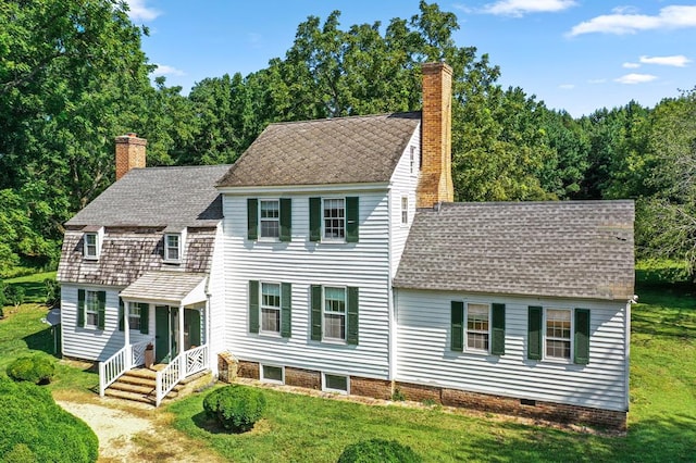 colonial inspired home with a front lawn