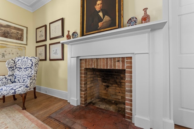 sitting room featuring a fireplace, hardwood / wood-style flooring, and crown molding