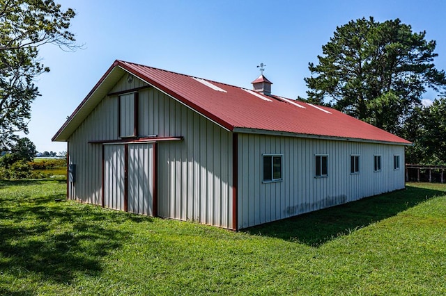 exterior space with an outdoor structure and a yard