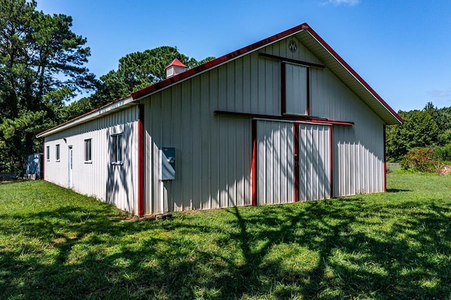 view of side of property with a yard and an outdoor structure