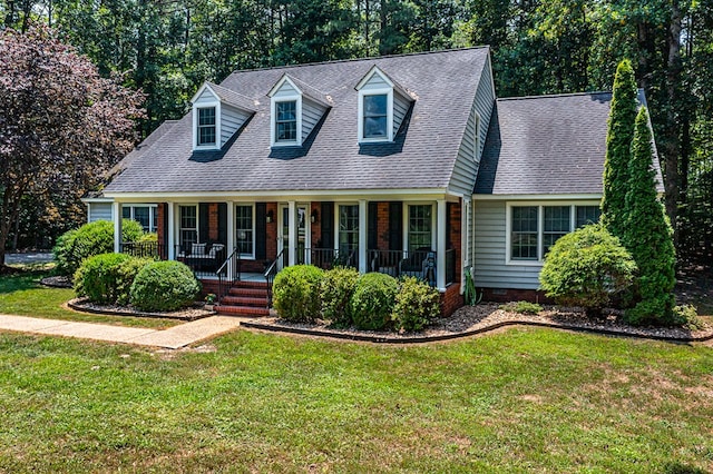 889 Taylors Creek Rd, Weems, VA 22576 - new england style home with a porch, a front yard, and roof with shingles
