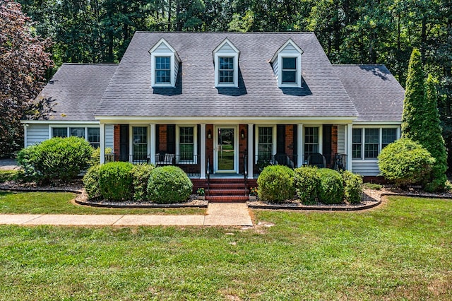 889 Taylors Creek Rd, Weems, VA 22576 - cape cod house featuring a porch, a front yard, and roof with shingles