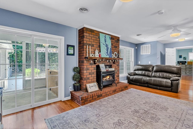 889 Taylors Creek Rd, Weems, VA 22576 - living area with ceiling fan, a wood stove, and wood finished floors