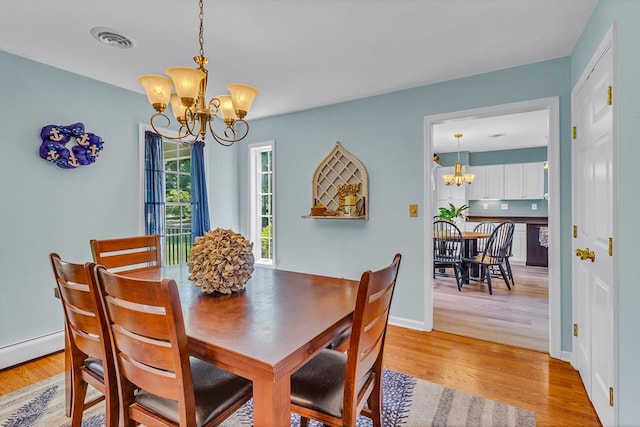 889 Taylors Creek Rd, Weems, VA 22576 - dining area featuring a chandelier and light wood-type flooring
