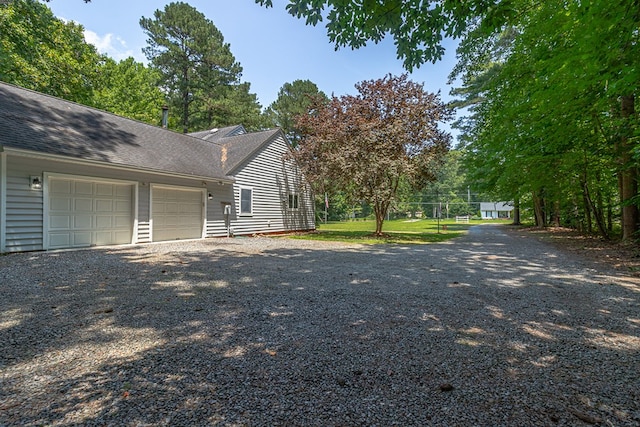 889 Taylors Creek Rd, Weems, VA 22576 - view of property exterior with a garage, driveway, and a shingled roof