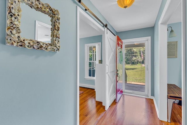 889 Taylors Creek Rd, Weems, VA 22576 - foyer entrance with a barn door, wood finished floors, and baseboard heating