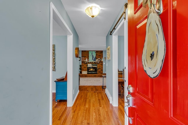 889 Taylors Creek Rd, Weems, VA 22576 - entryway featuring light wood-style flooring and a brick fireplace