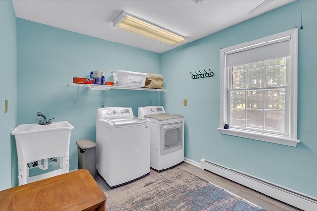 889 Taylors Creek Rd, Weems, VA 22576 - laundry room featuring a baseboard radiator, washing machine and dryer, and wood finished floors