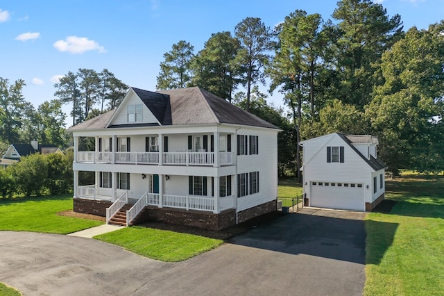 480 Rockingham Rd, Dunnsville, VA 22454 - view of front of property with covered porch, a balcony, an outbuilding, a front lawn, and driveway