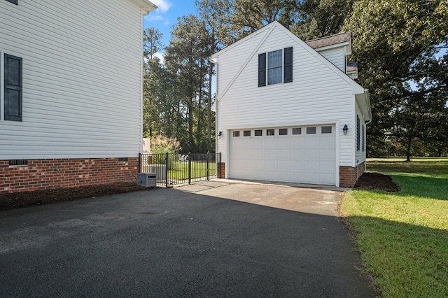 480 Rockingham Rd, Dunnsville, VA 22454 - view of side of property with an attached garage, a lawn, crawl space, aphalt driveway, and fence