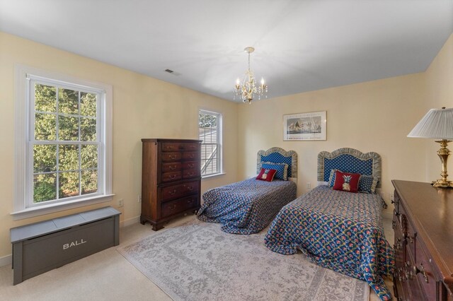 480 Rockingham Rd, Dunnsville, VA 22454 - bedroom featuring a notable chandelier, baseboards, visible vents, and carpet floors