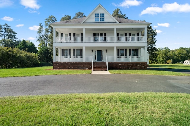 480 Rockingham Rd, Dunnsville, VA 22454 - view of front of home featuring a front yard, covered porch, and a balcony