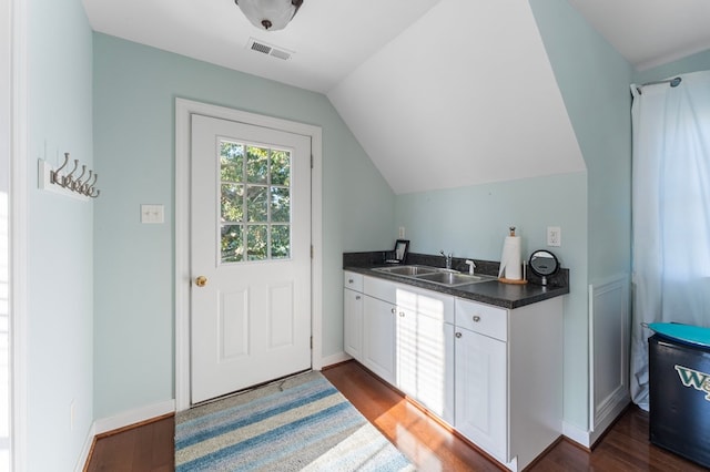 480 Rockingham Rd, Dunnsville, VA 22454 - kitchen with dark countertops, dark wood-type flooring, visible vents, lofted ceiling, and a sink