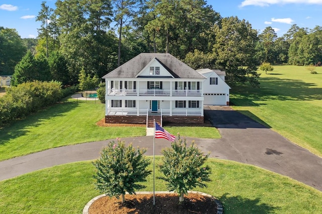 480 Rockingham Rd, Dunnsville, VA 22454 - view of front of home featuring a garage, a front yard, a balcony, and covered porch