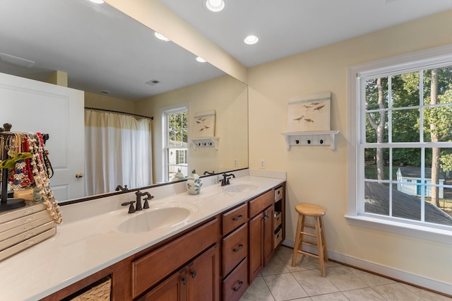 480 Rockingham Rd, Dunnsville, VA 22454 - bathroom with tile patterned flooring, recessed lighting, a sink, double vanity, and baseboards